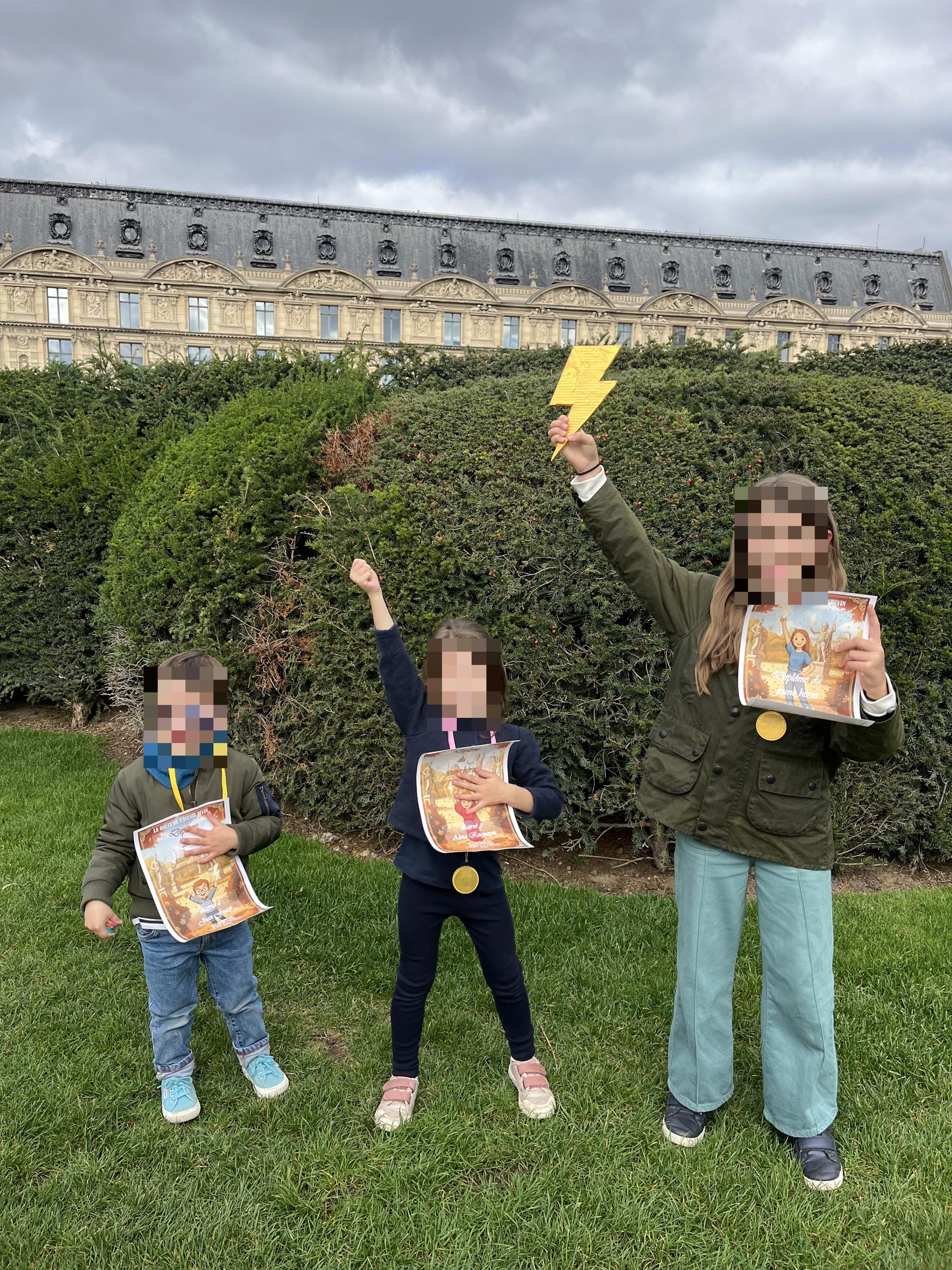 Three children celebrating with certificates after a quest in Paris