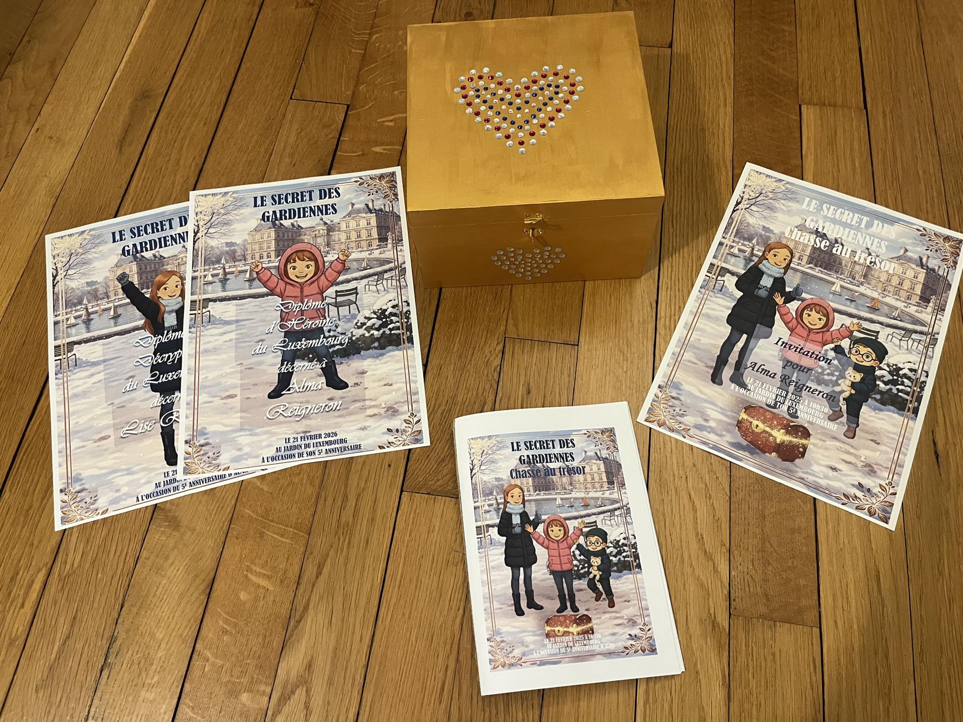 Printed quest booklet, invitation, and closed treasure box on a wooden floor